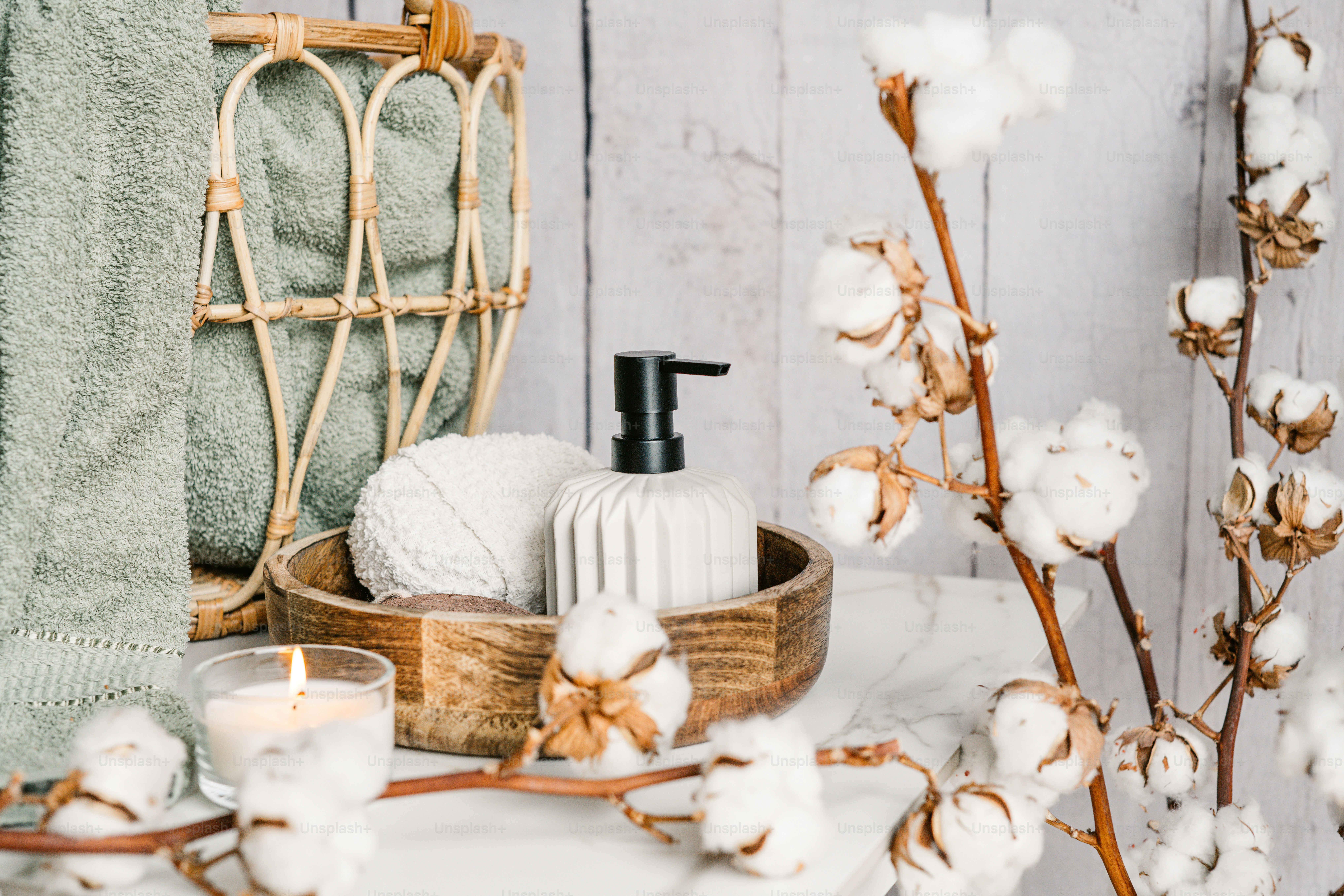 a basket of cotton and a candle on a table