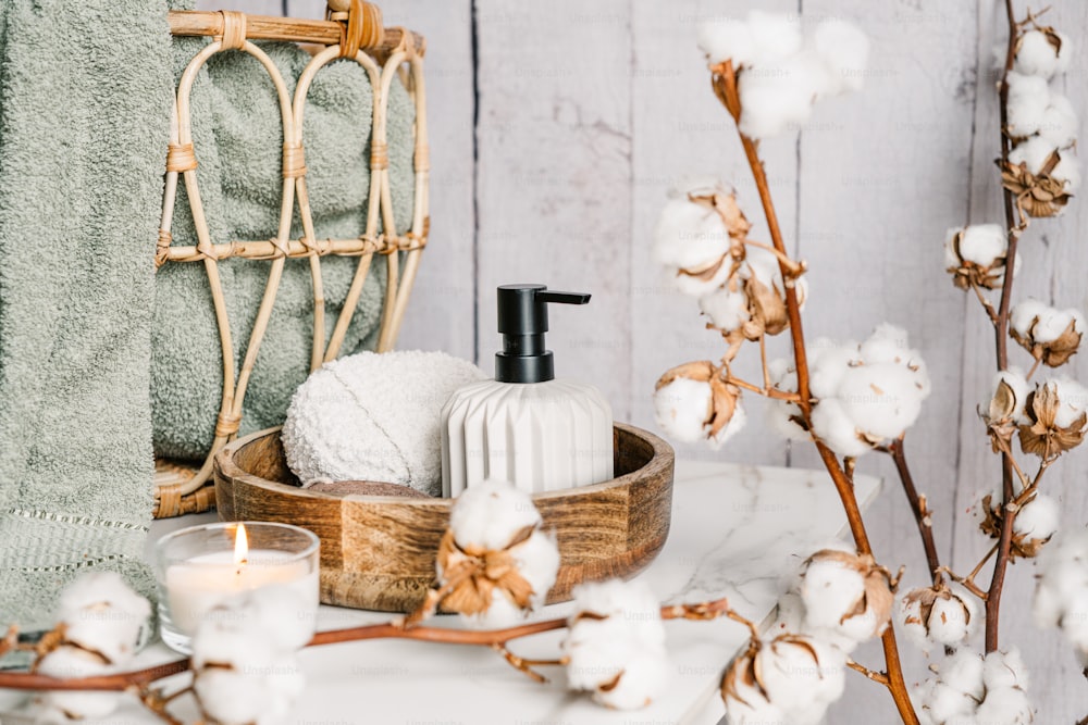 a basket of cotton and a candle on a table