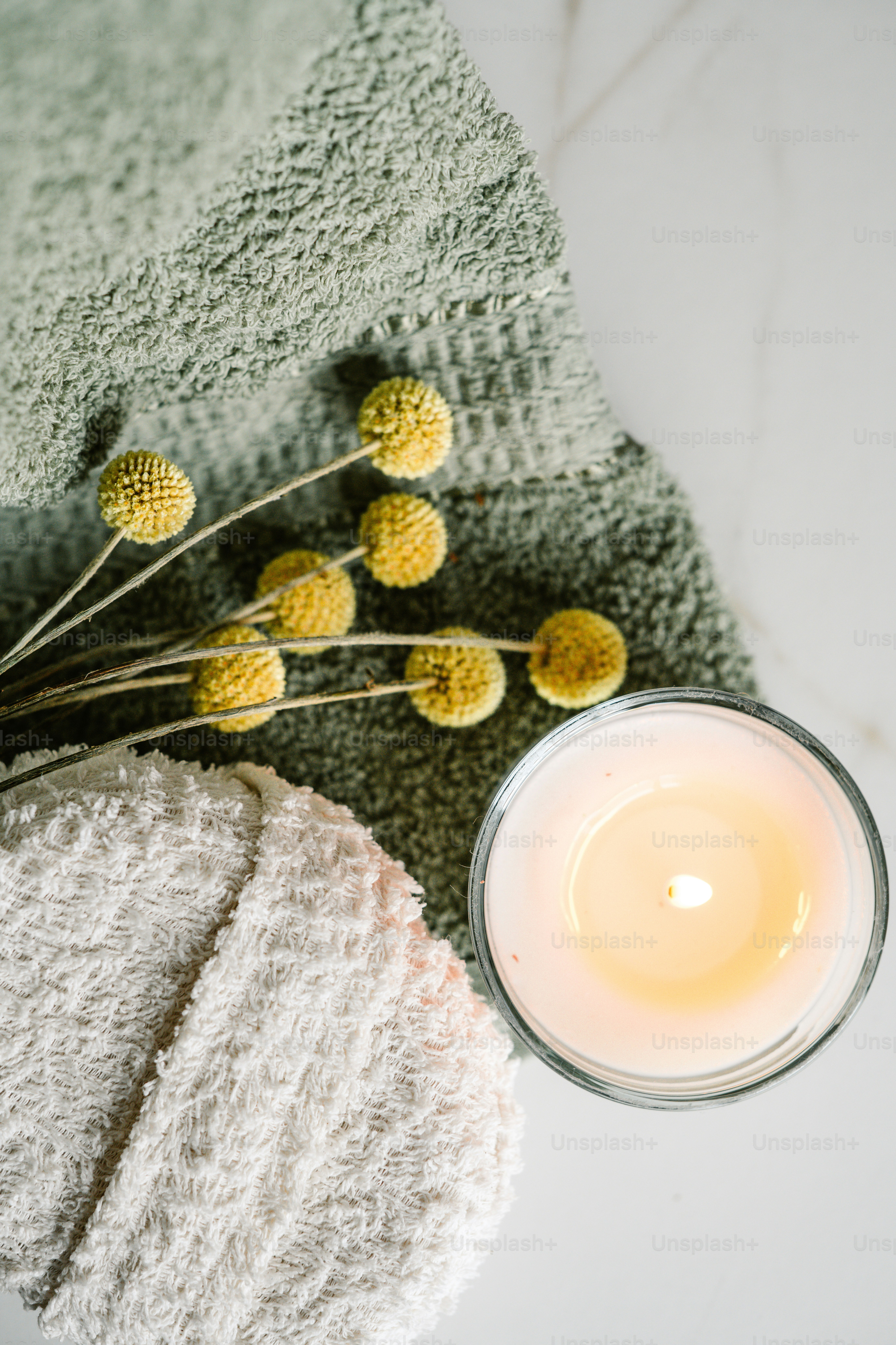 a candle and a towel on a table