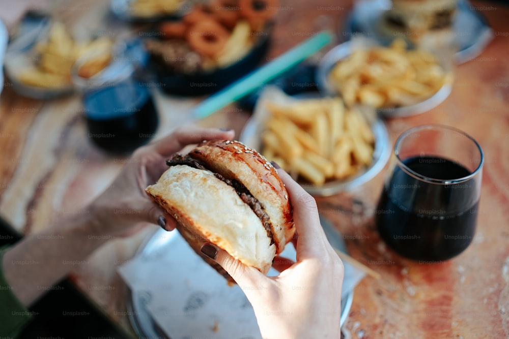 a person holding a sandwich in their hand