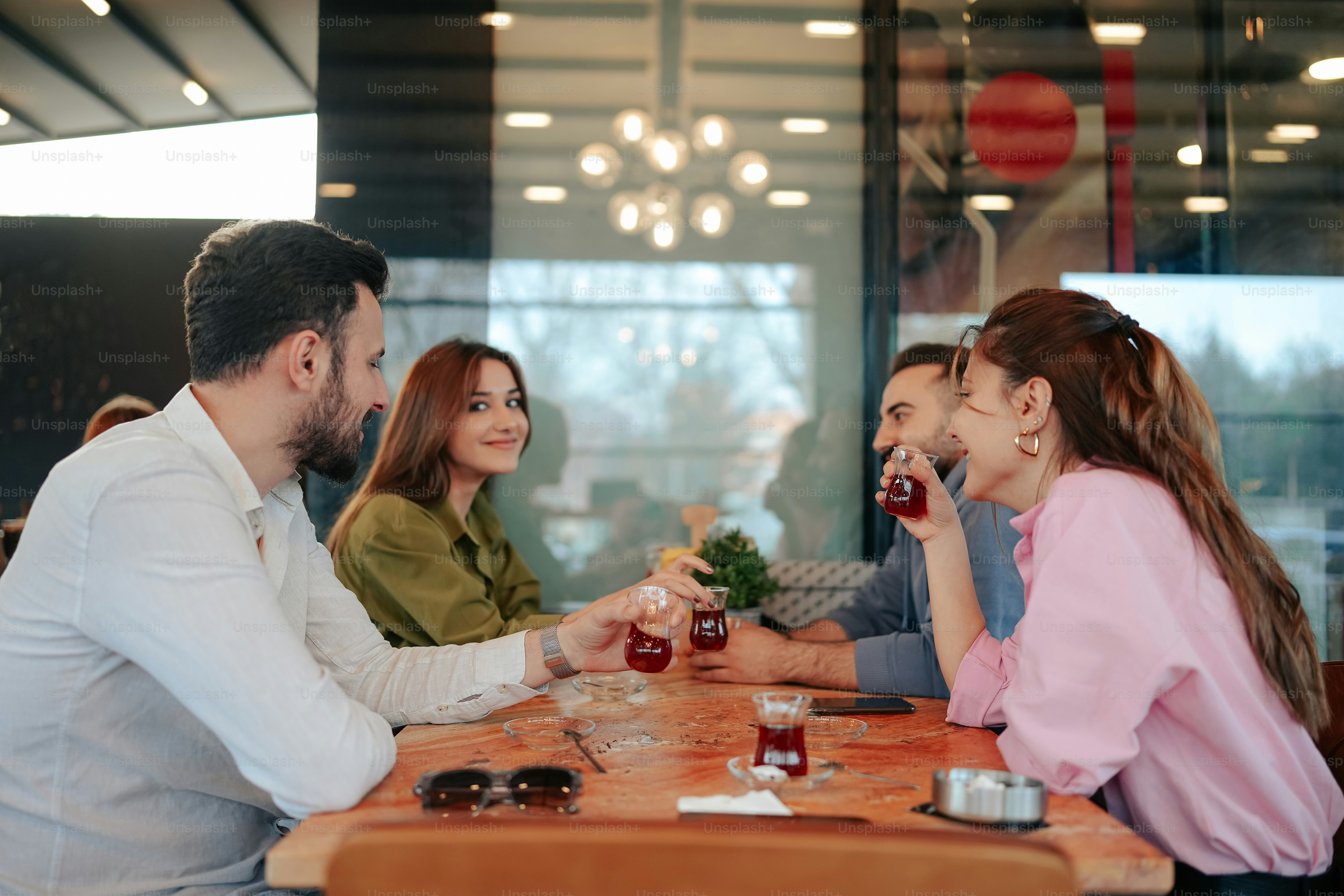 a group of people sitting at a table with drinks