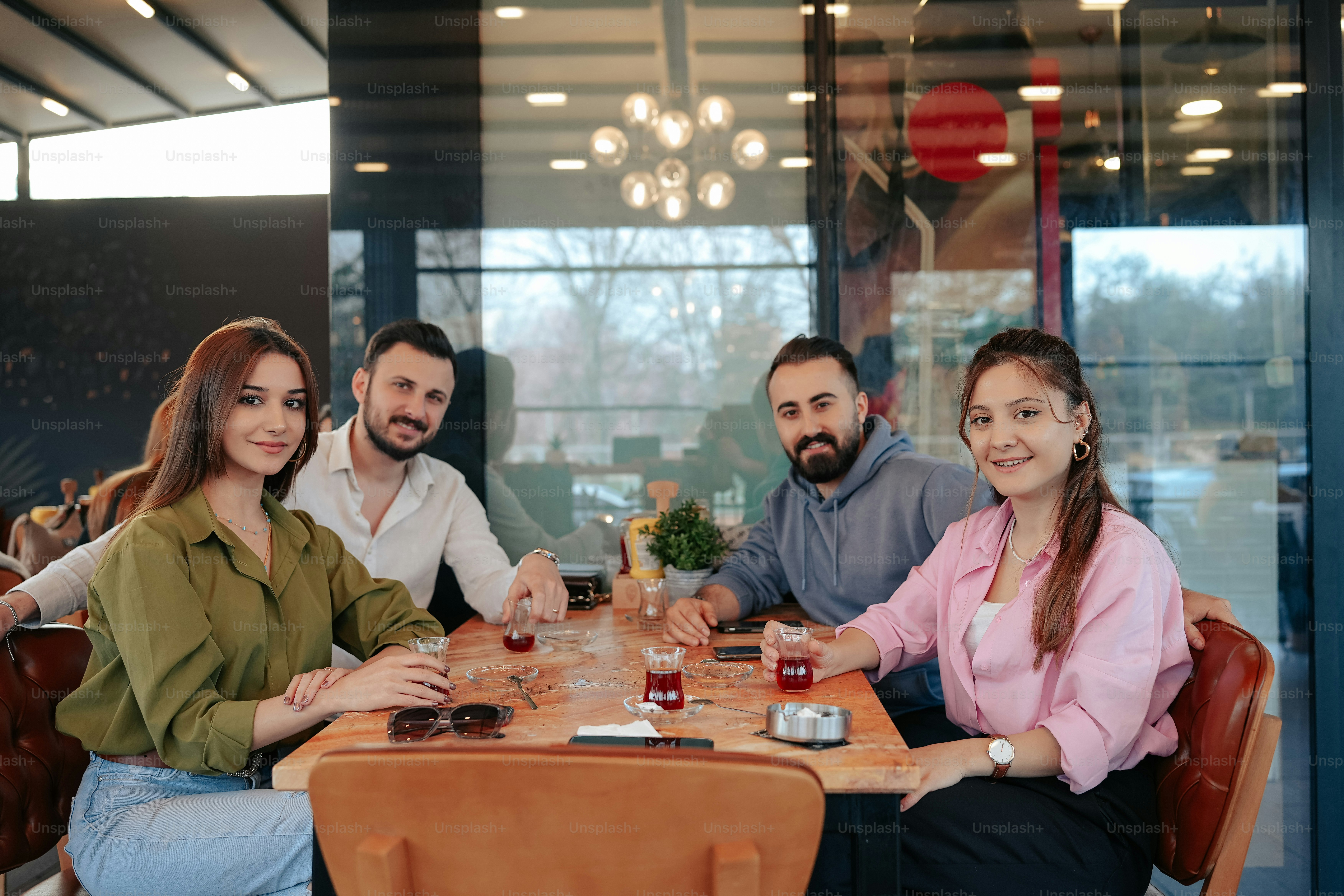 a group of people sitting around a wooden table
