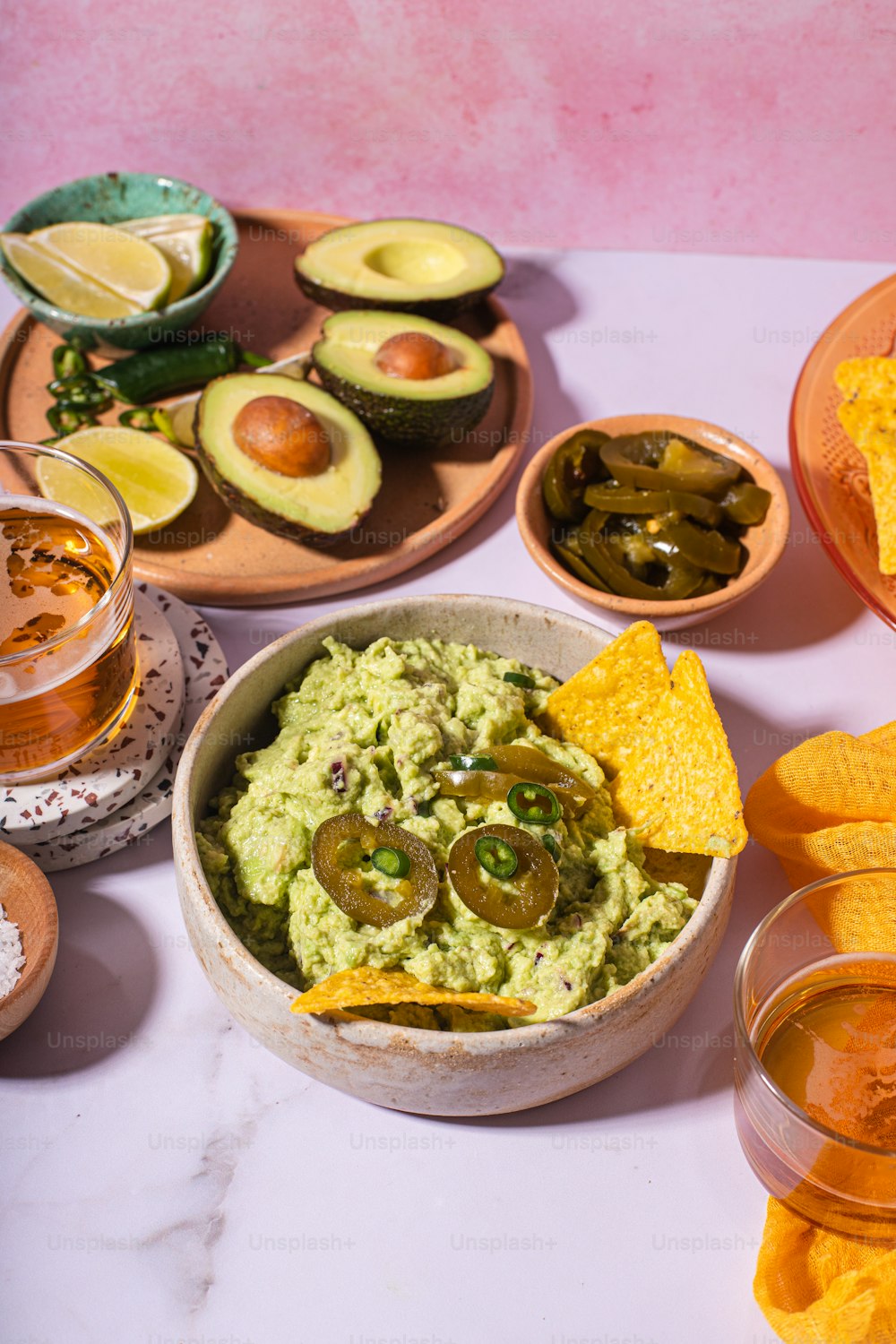 a bowl of guacamole, chips, and salsa on a table