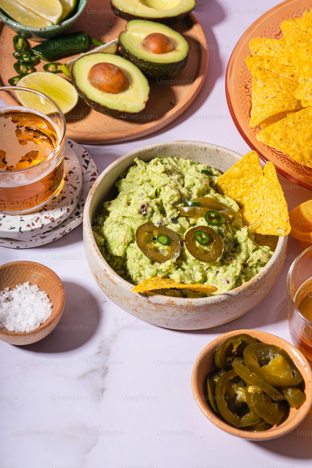 a bowl of guacamole and chips on a table