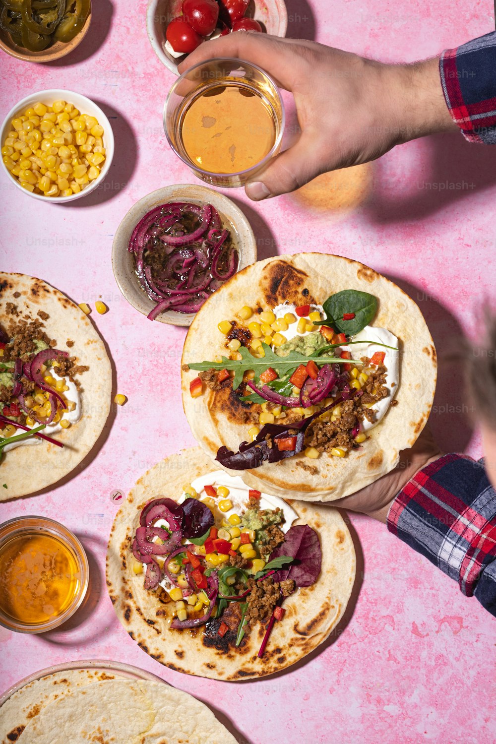 a table topped with tacos and bowls of food