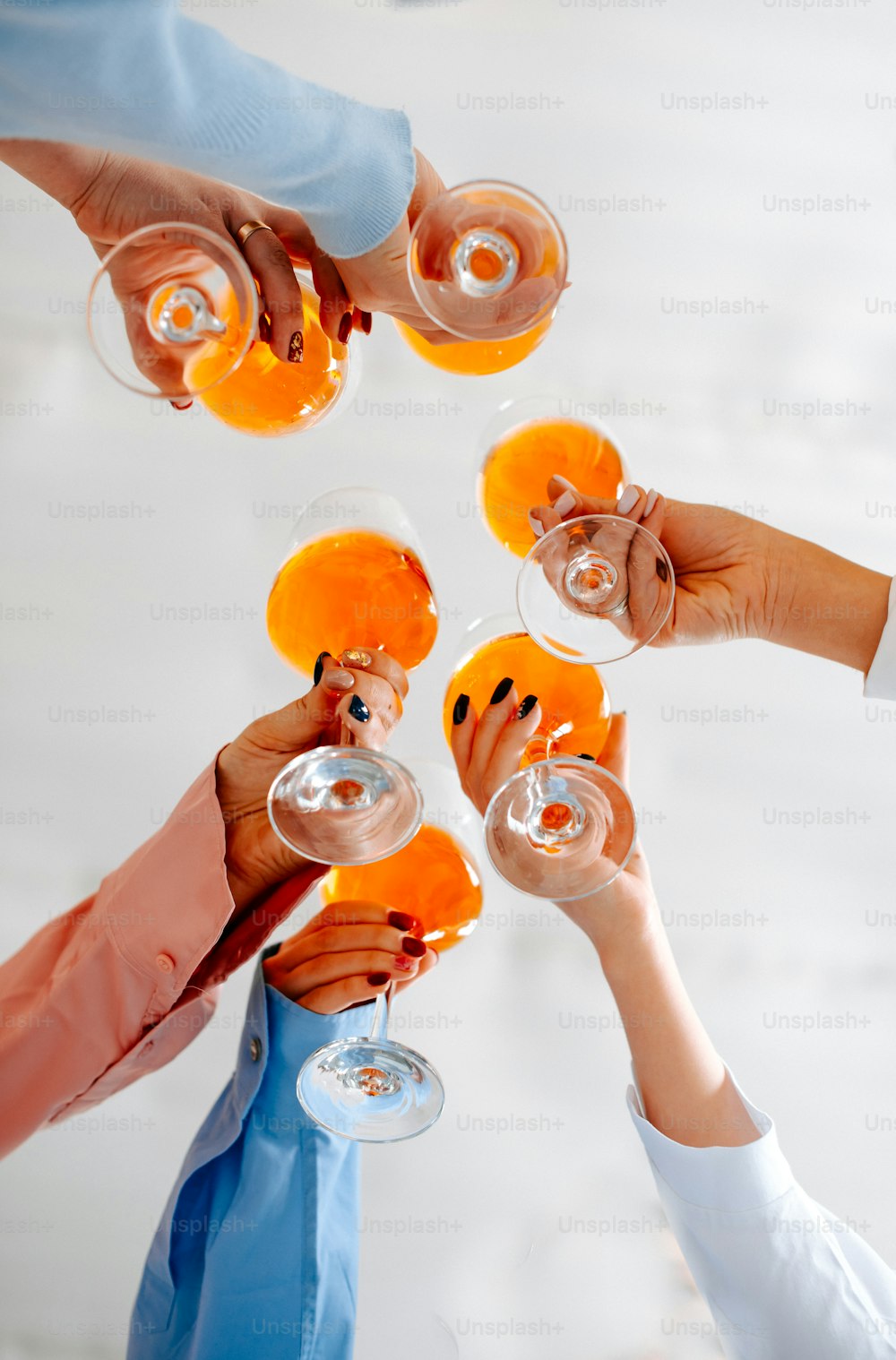 a group of people holding wine glasses in the air