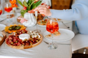 a table with a plate of food and a glass of wine