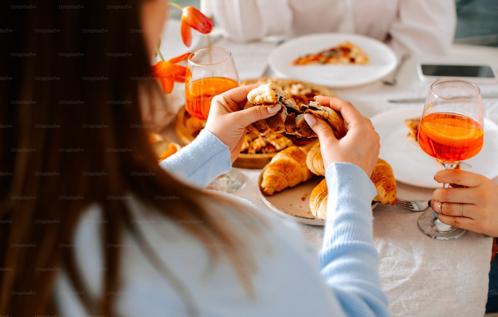 a group of people sitting around a table eating food