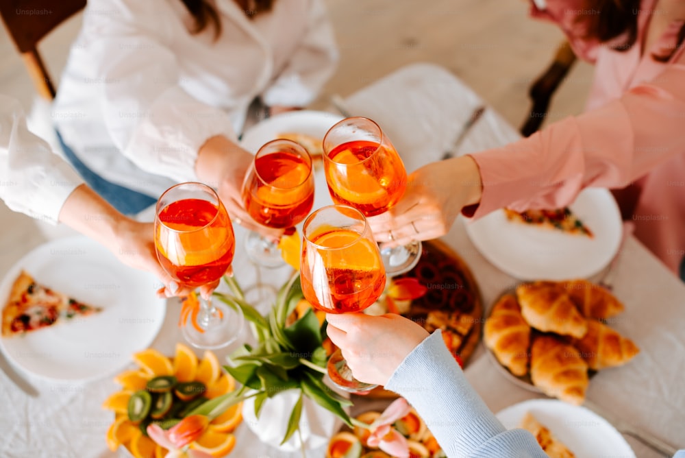 a group of people toasting glasses of wine