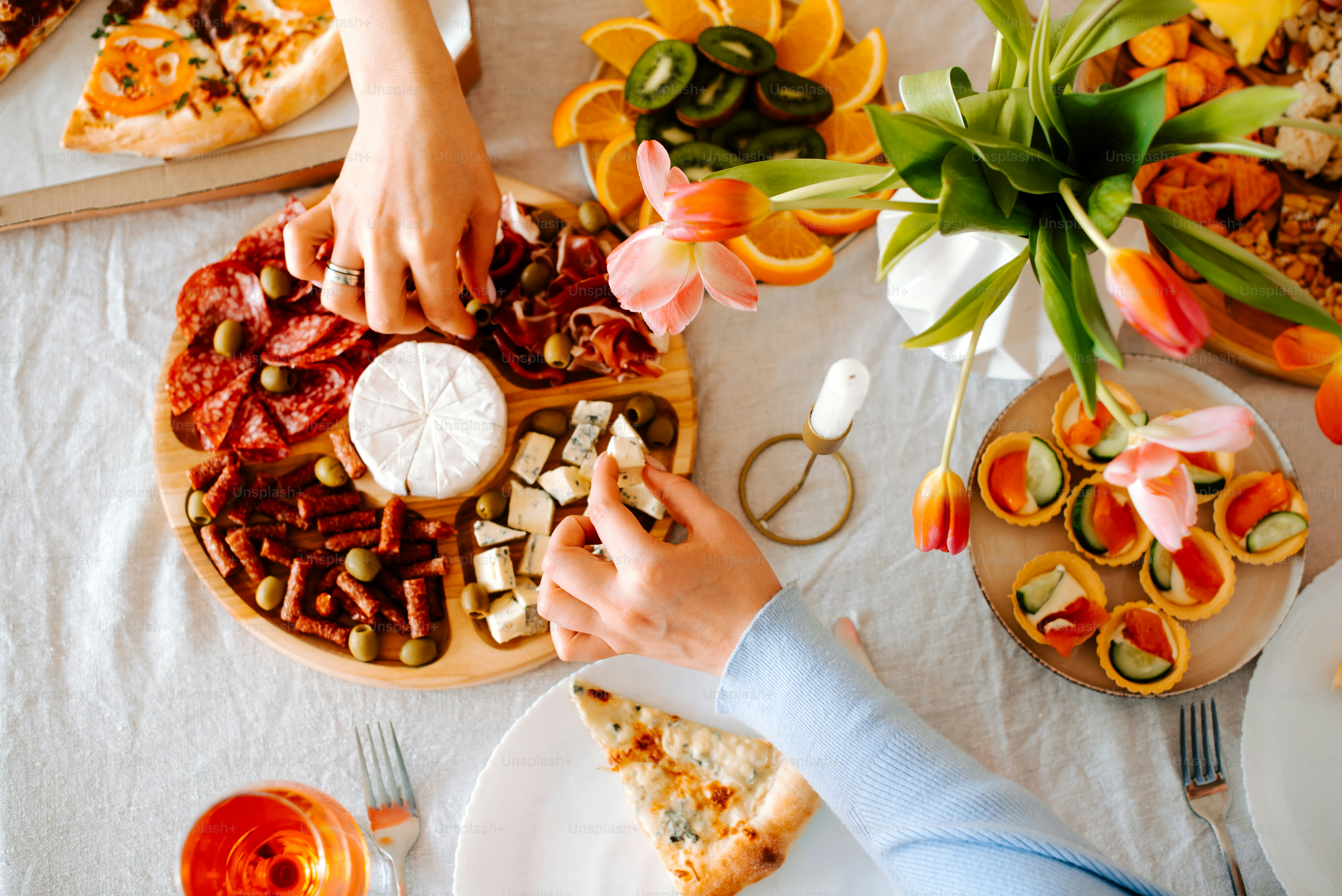 A table topped with a pizza covered in toppings photo – Sharing food ...