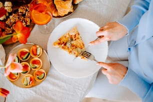 a person eating a slice of pizza on a plate