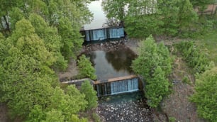 an aerial view of a river running through a forest