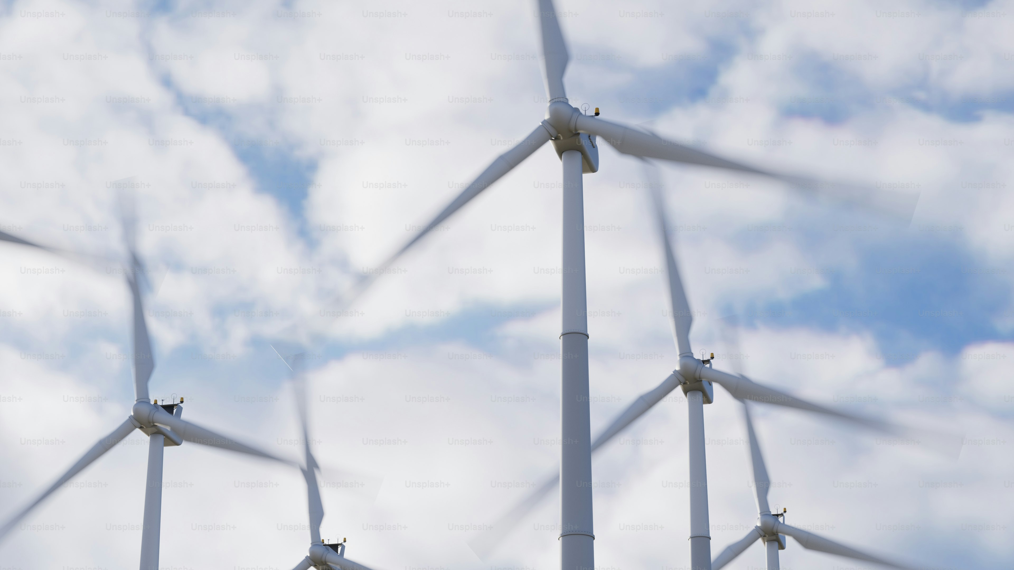 a group of windmills that are standing in the grass