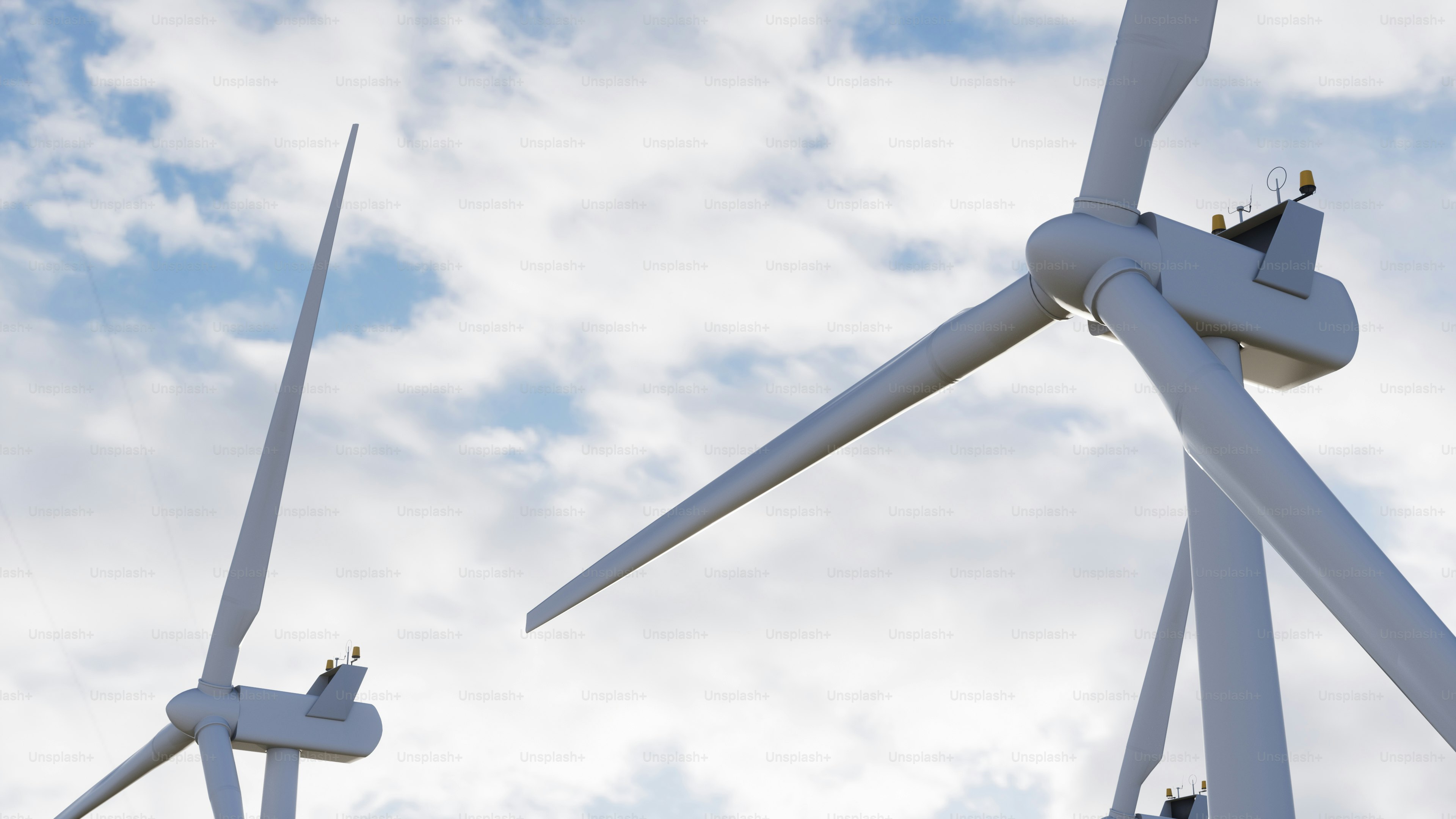 A couple of windmills that are next to each other photo – Clean energy ...