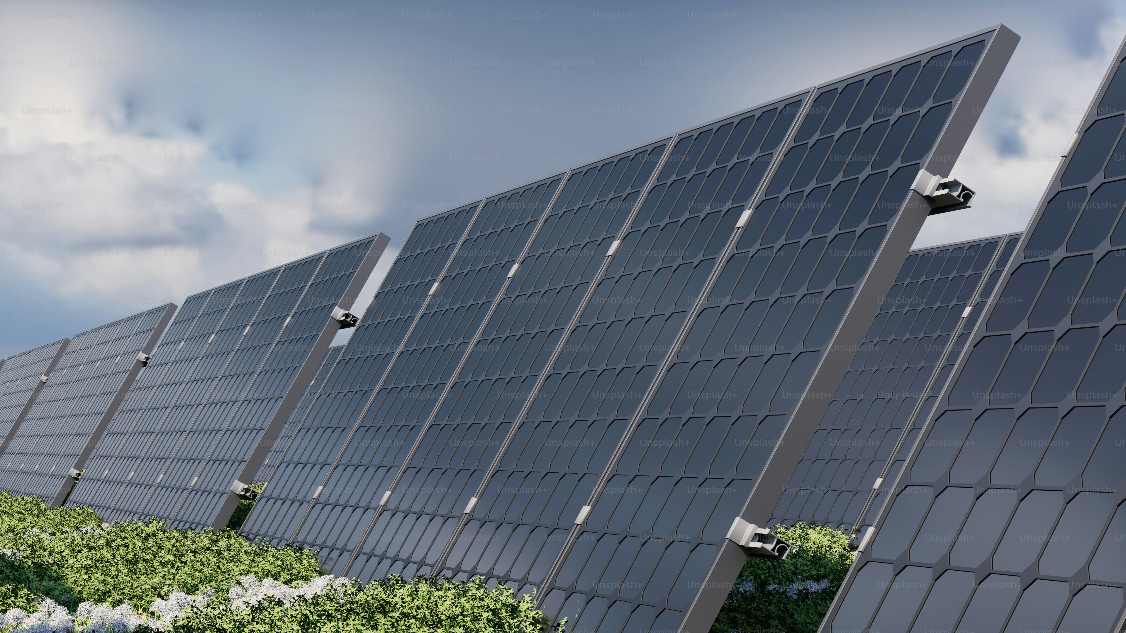 A row of solar panels sitting on top of a lush green field photo ...