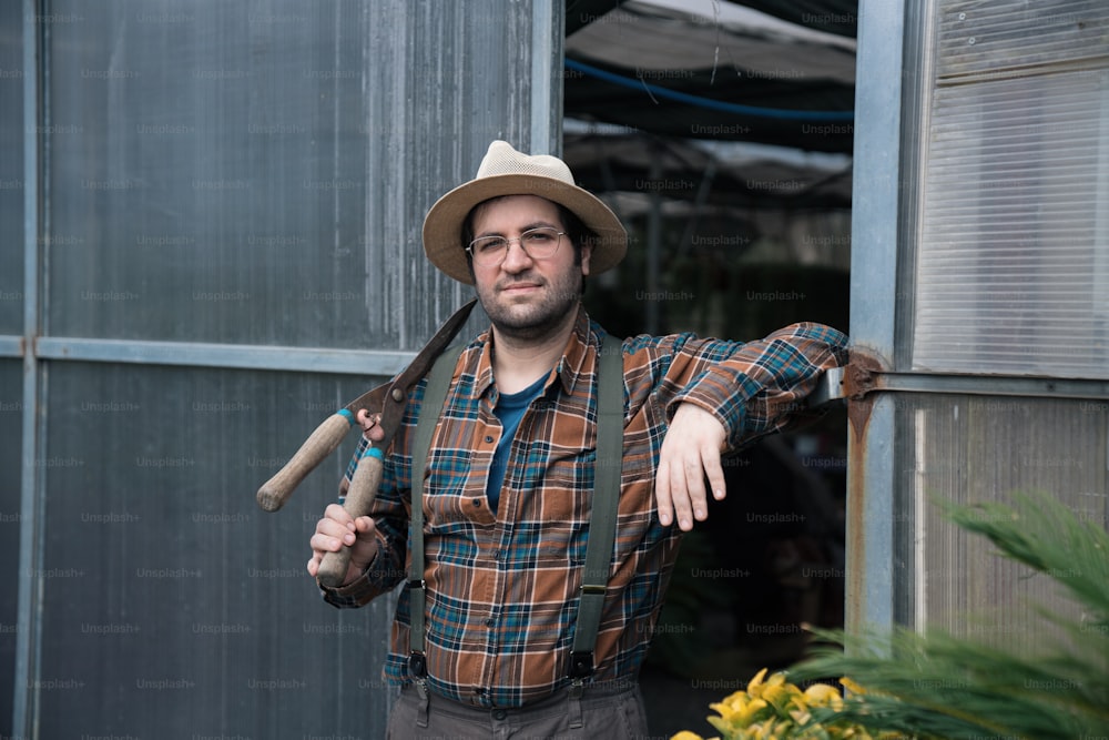 a man wearing a hat and holding a baseball bat