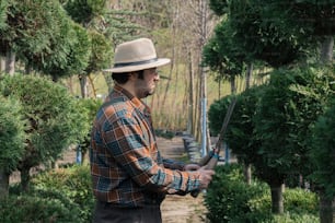 a man holding a pair of scissors in a garden
