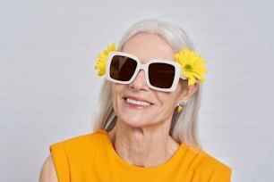 an older woman with sunflowers in her hair