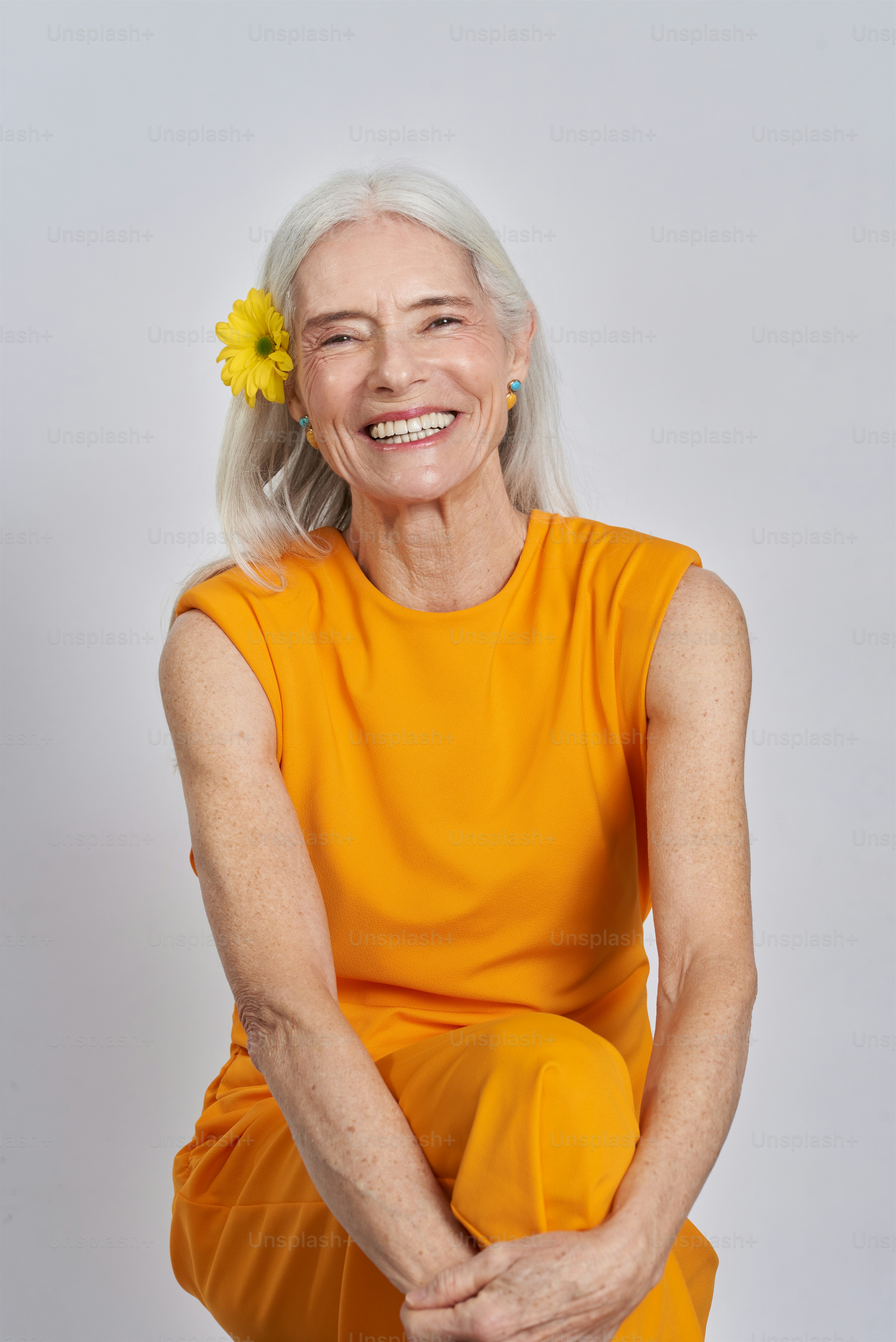 an older woman with a flower in her hair