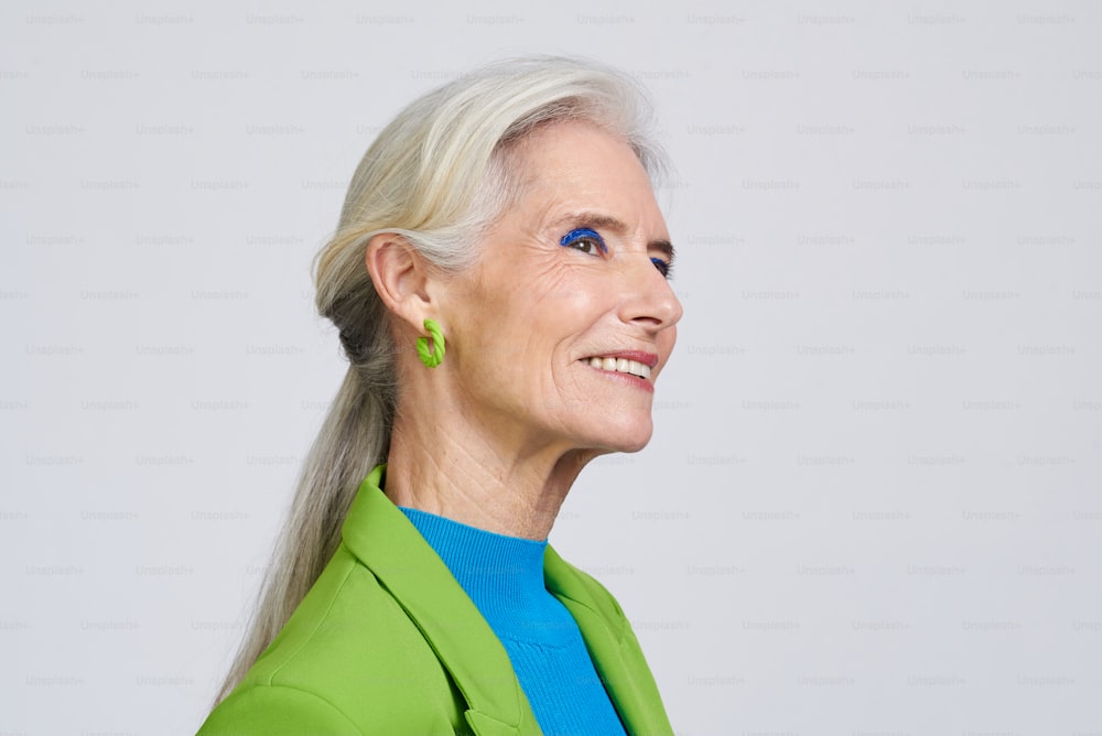 a woman in a green jacket and blue shirt