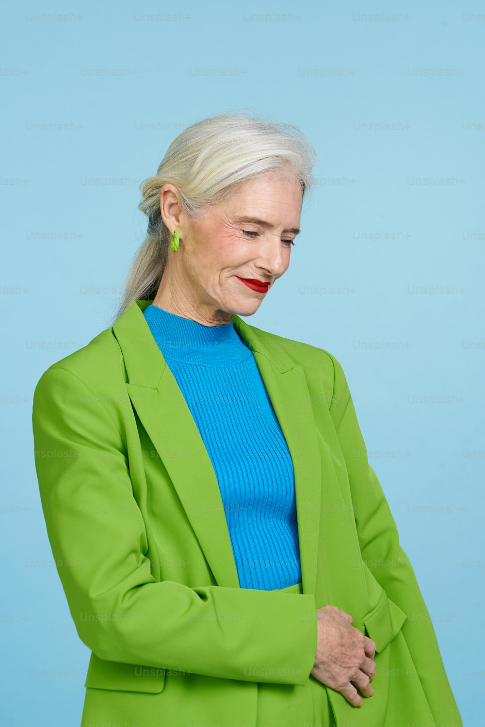 a woman in a green jacket and blue top