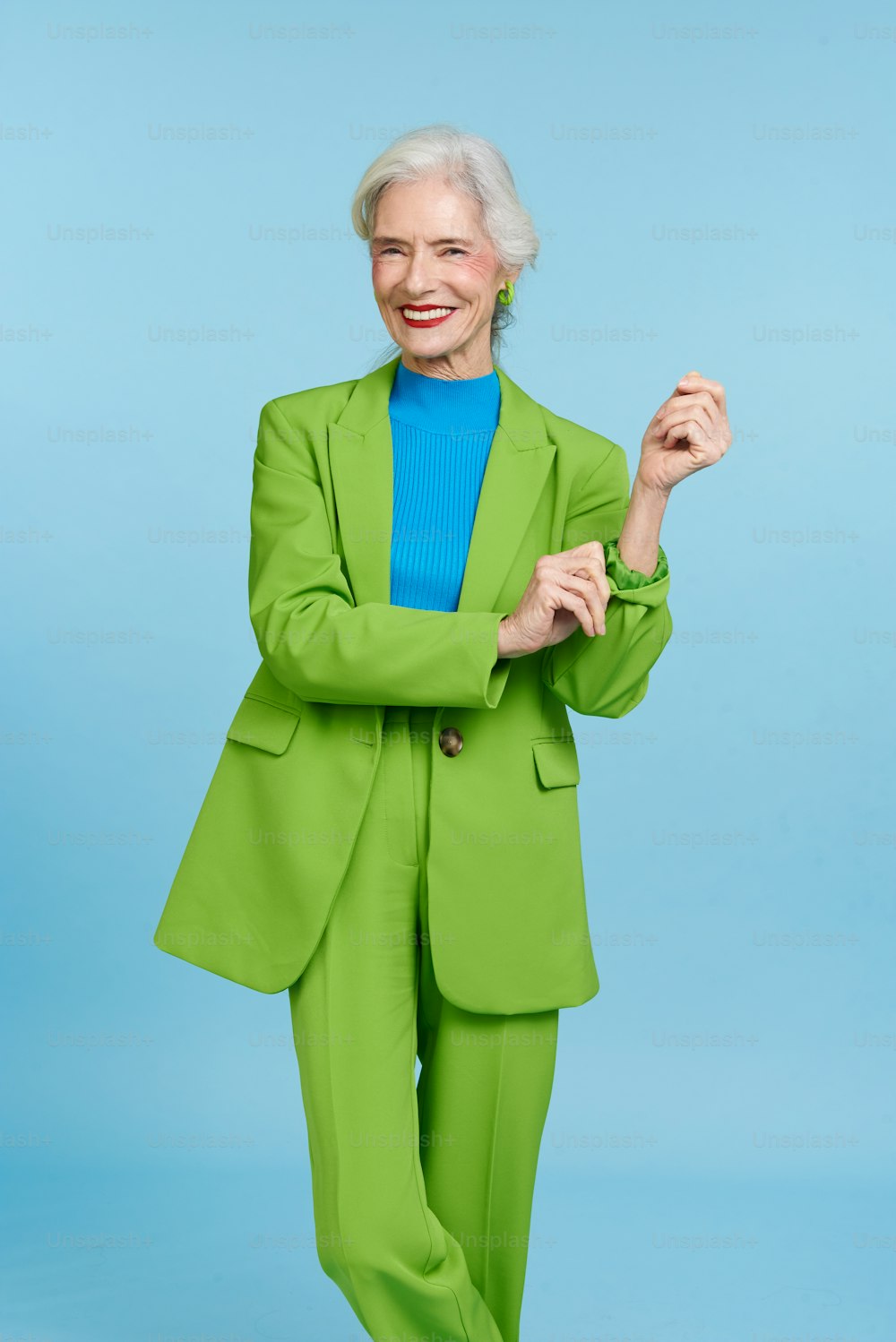 a woman in a green suit posing for a picture