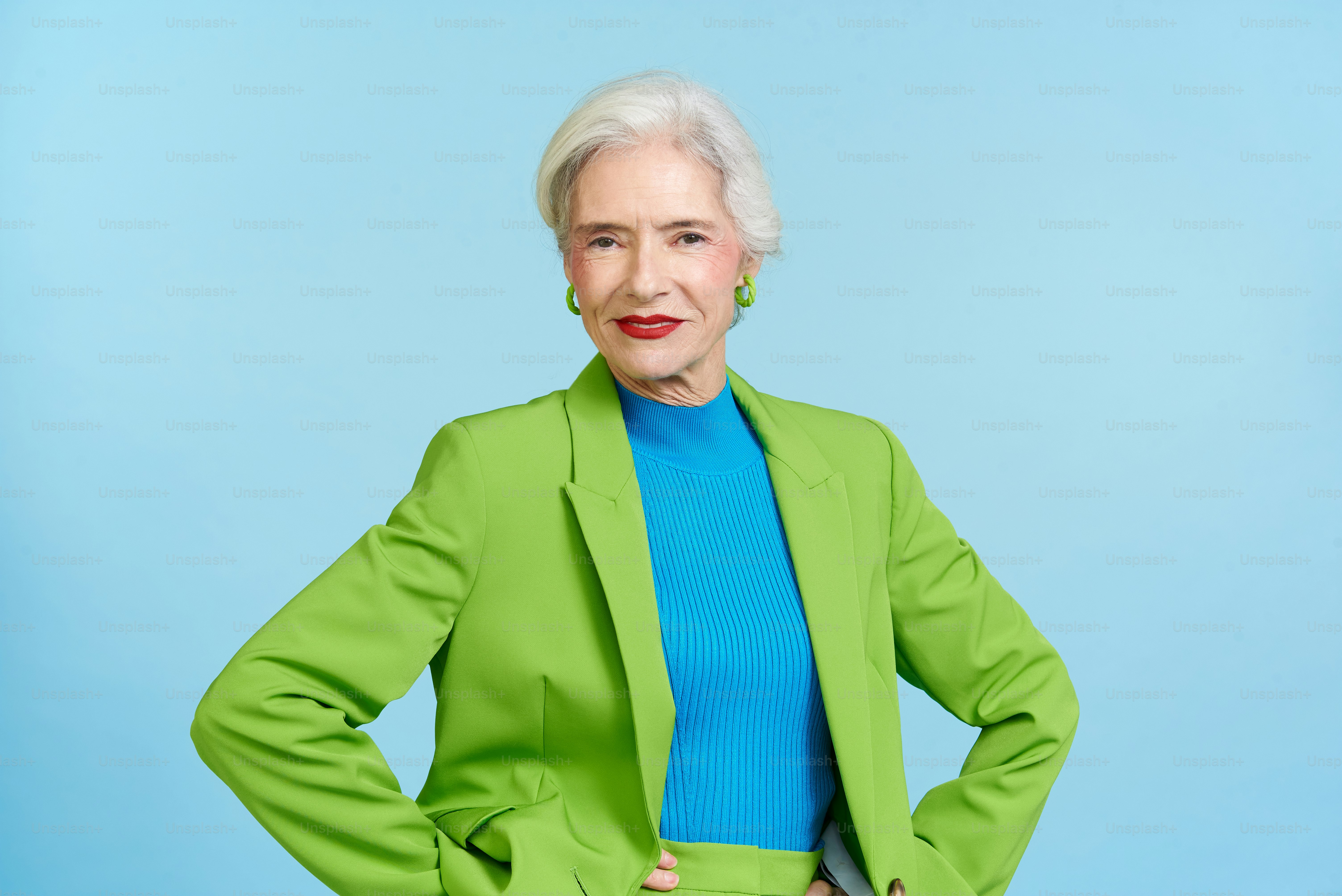 a woman in a green jacket and blue shirt
