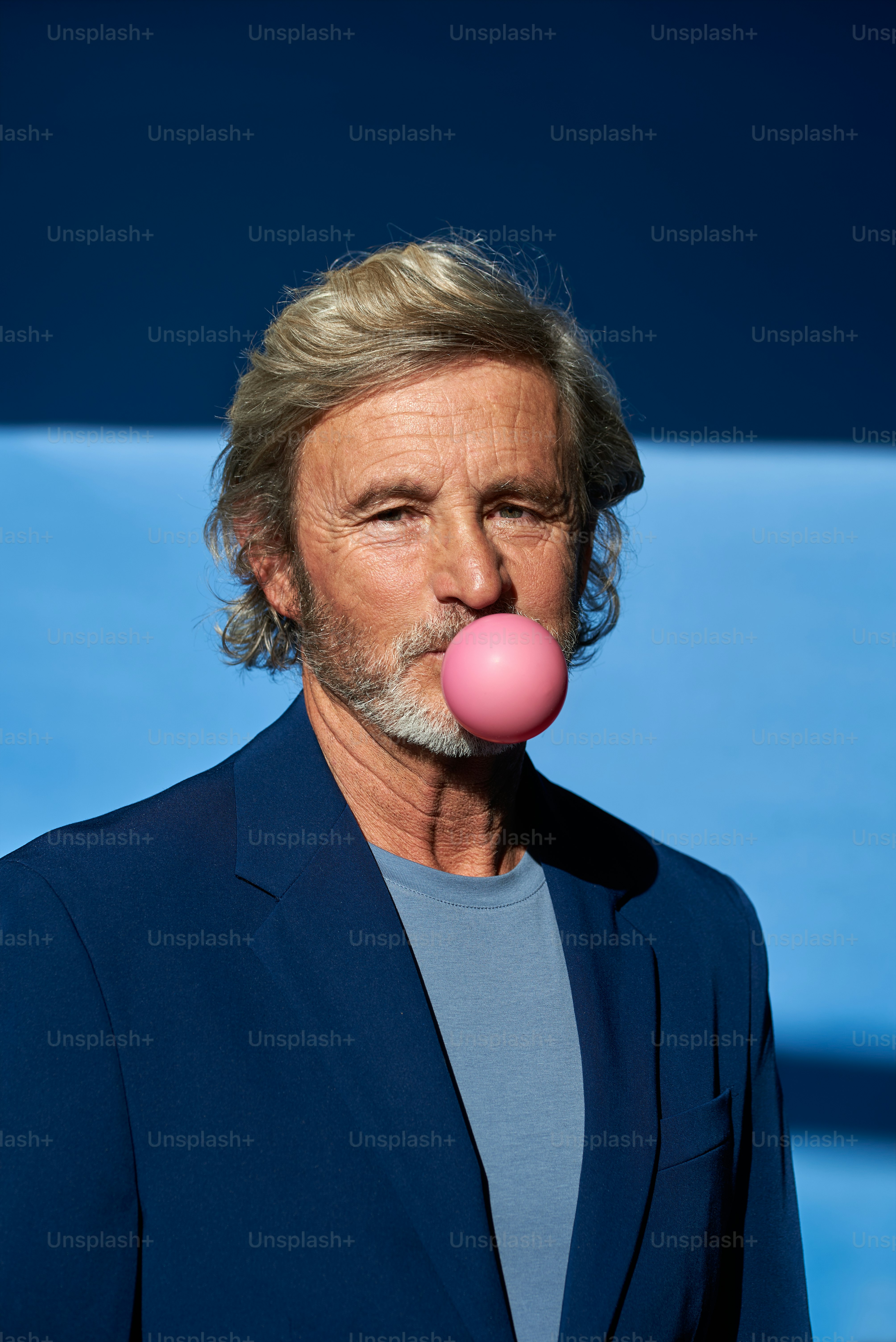 a man with a pink bubble in his mouth
