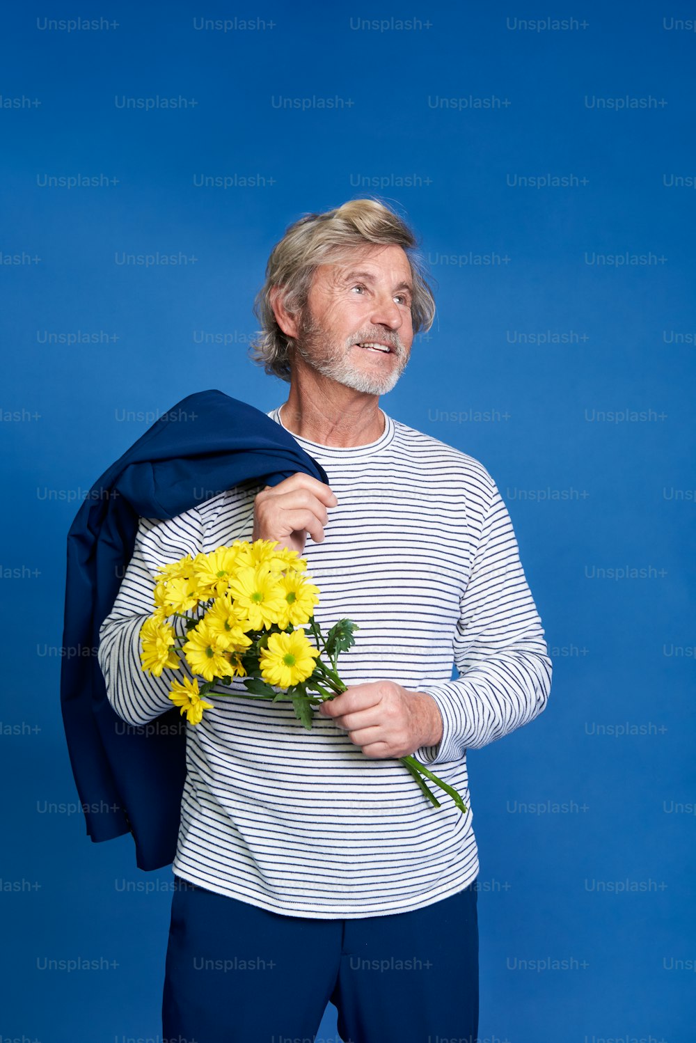 a man holding a bouquet of yellow flowers