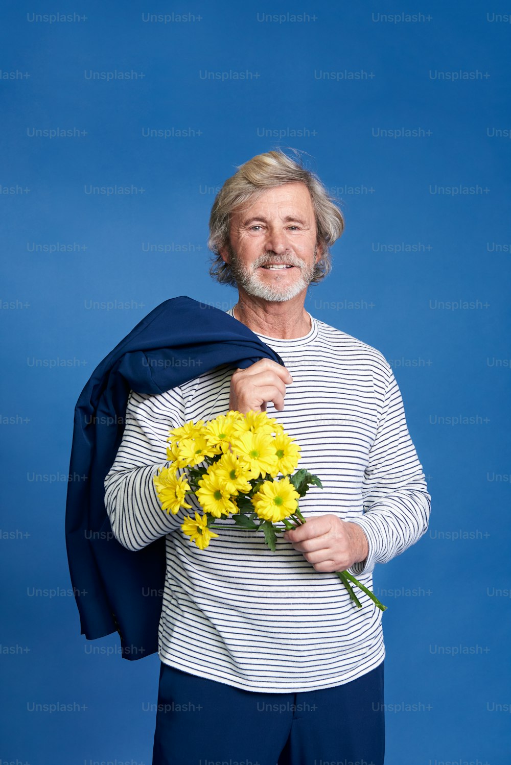 a man holding a bouquet of yellow flowers