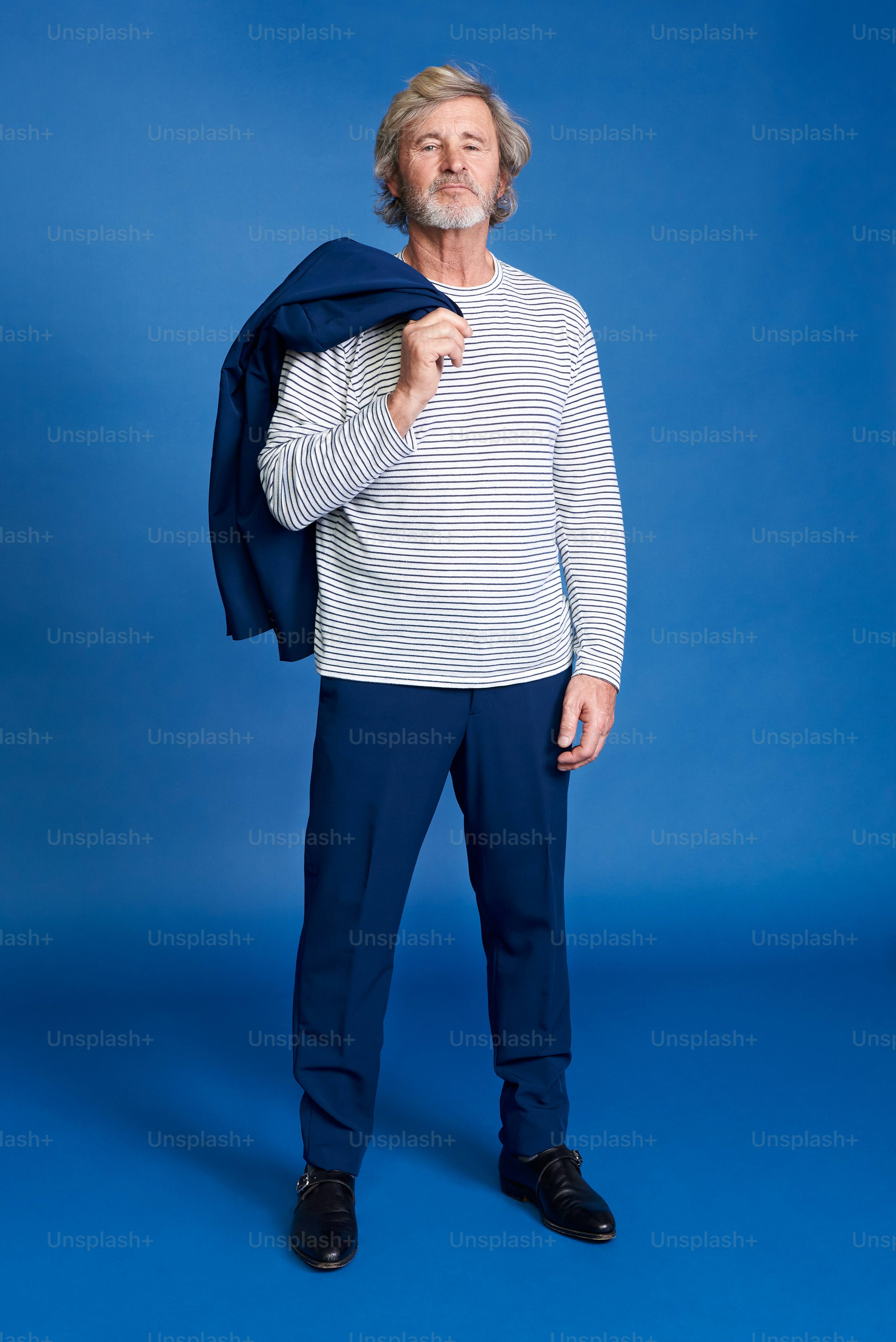 a man in a white shirt and blue pants