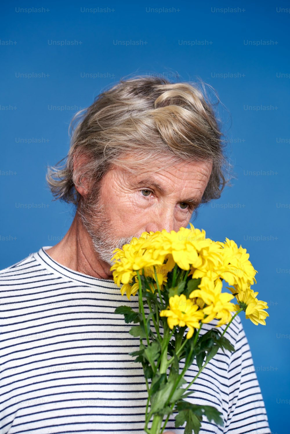 a man holding a bouquet of yellow flowers