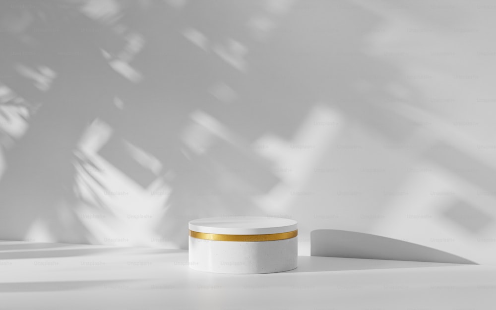 a white jar with a gold stripe sitting on a table
