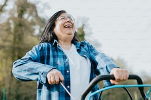 a woman is laughing while riding a tractor