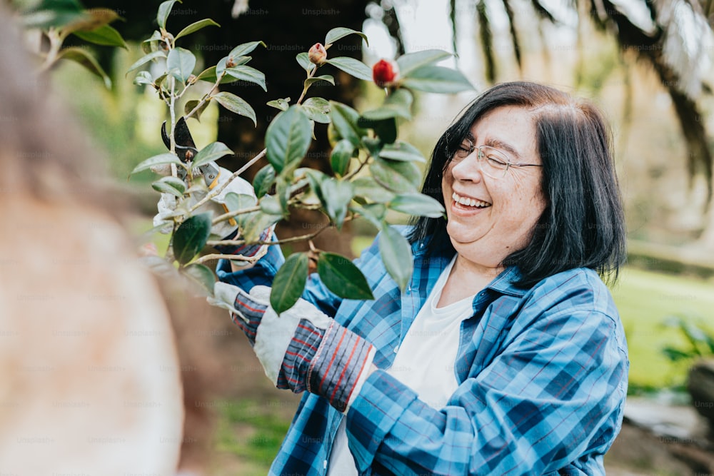 a woman is smiling and holding a plant