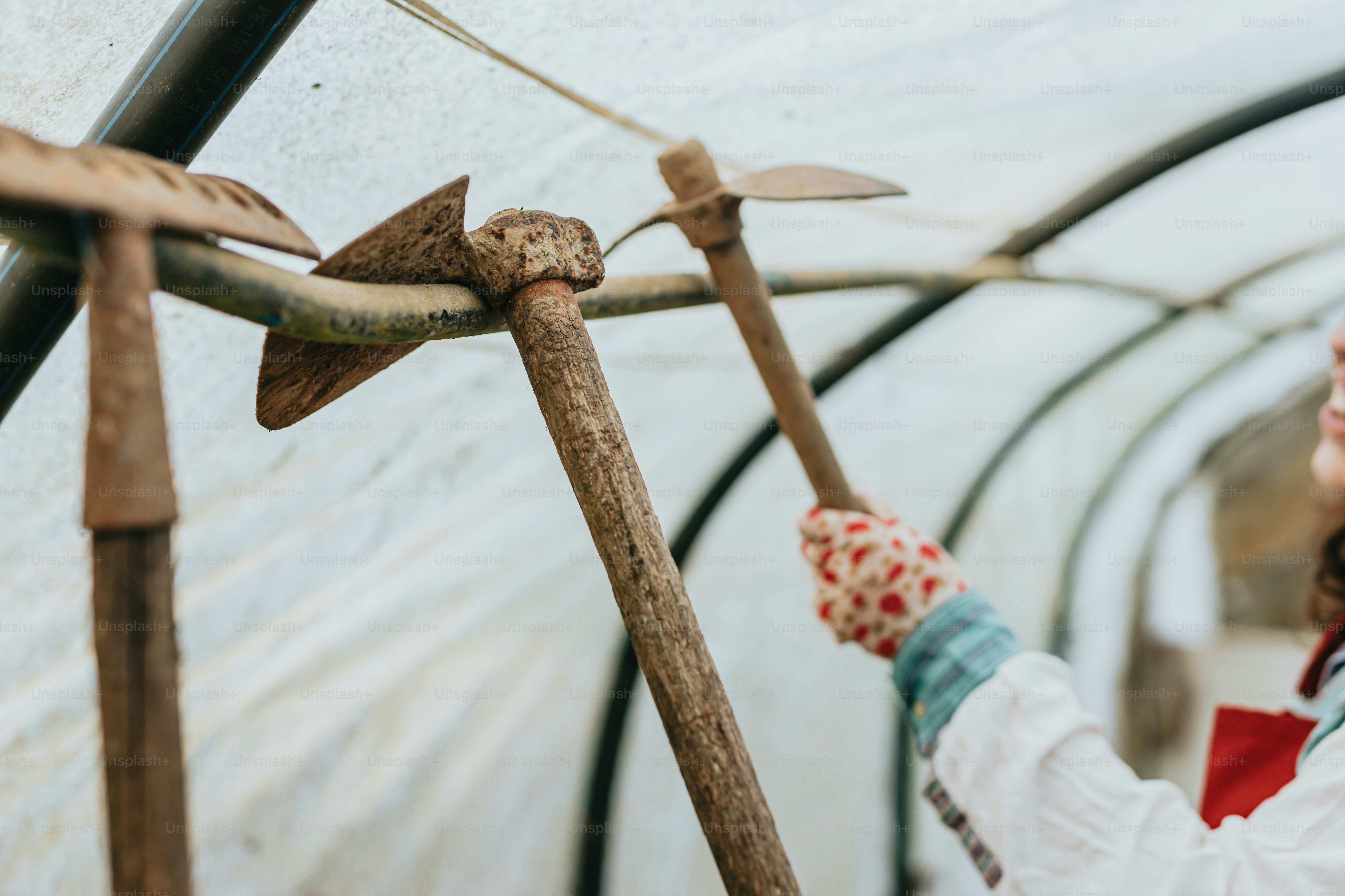a woman in a white coat holding a wooden stick