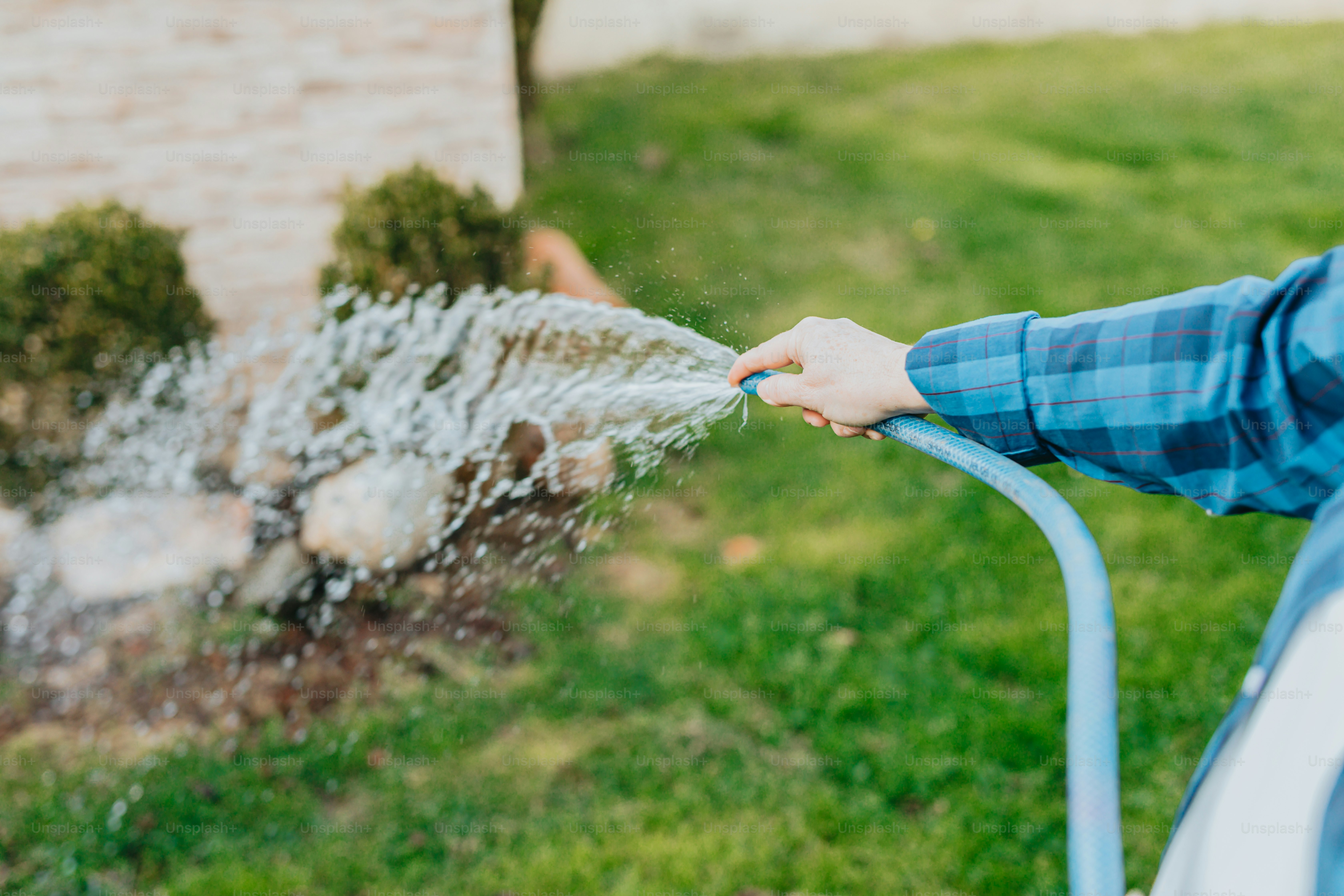 a person is spraying water from a hose
