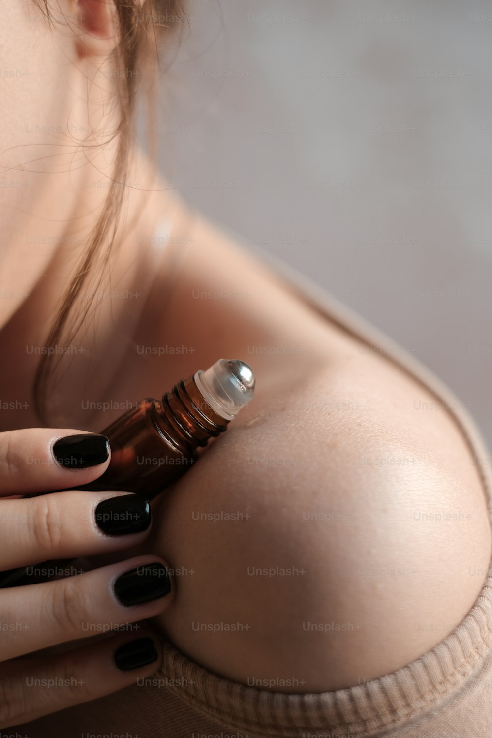 a woman holding a bottle of brown liquid