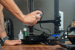 a man is working on a 3d printer