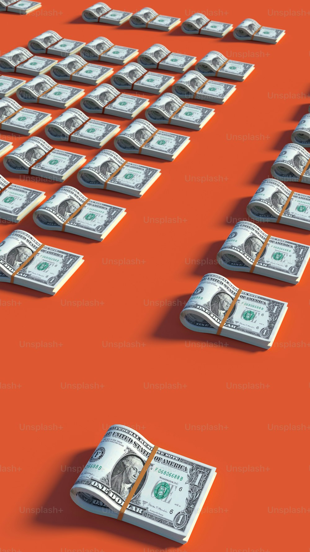 a bunch of money sitting on top of a red surface