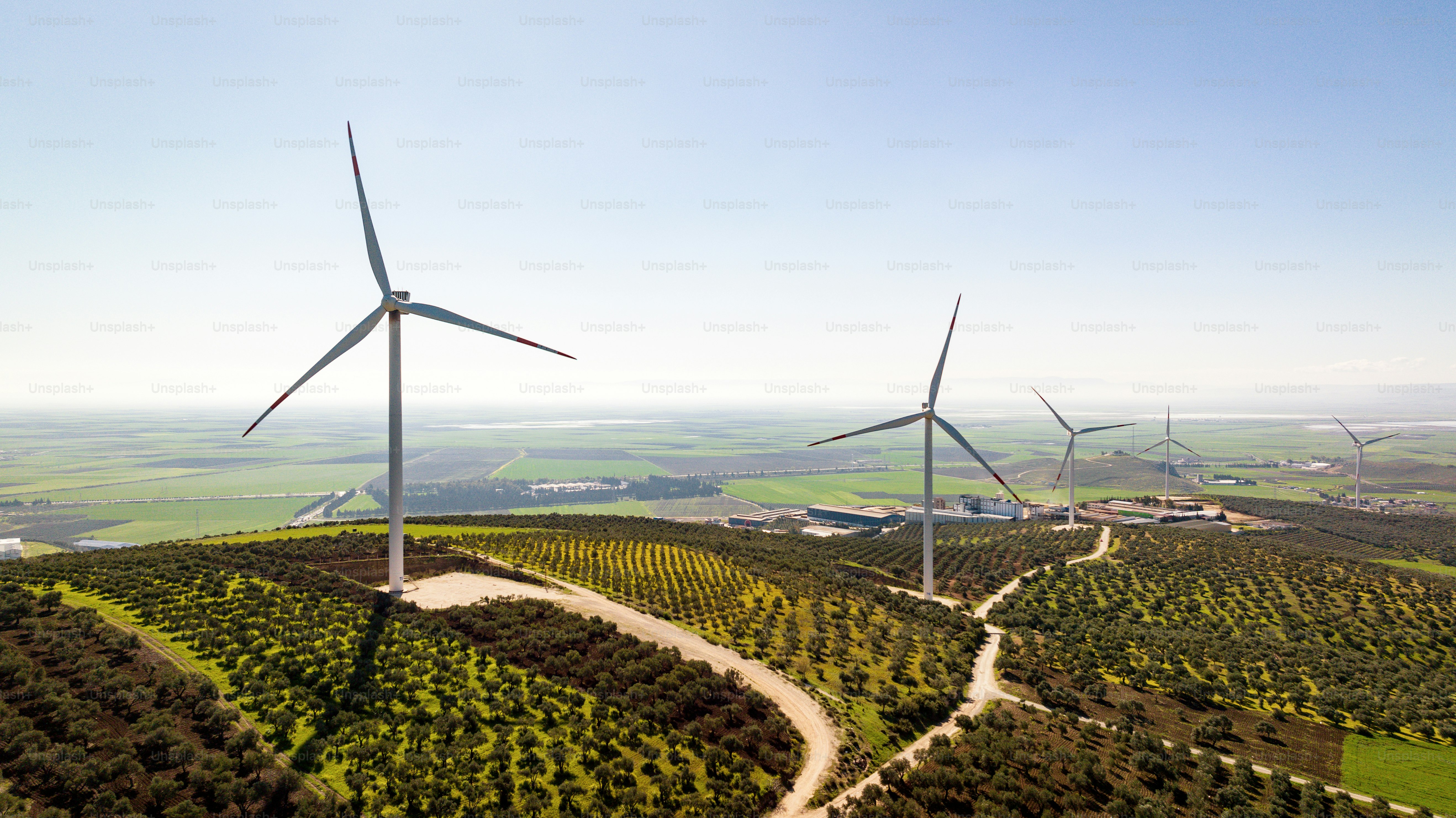 A group of wind turbines on top of a hill photo – Electricity Image on ...