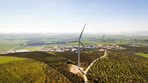 an aerial view of a wind farm with a wind turbine