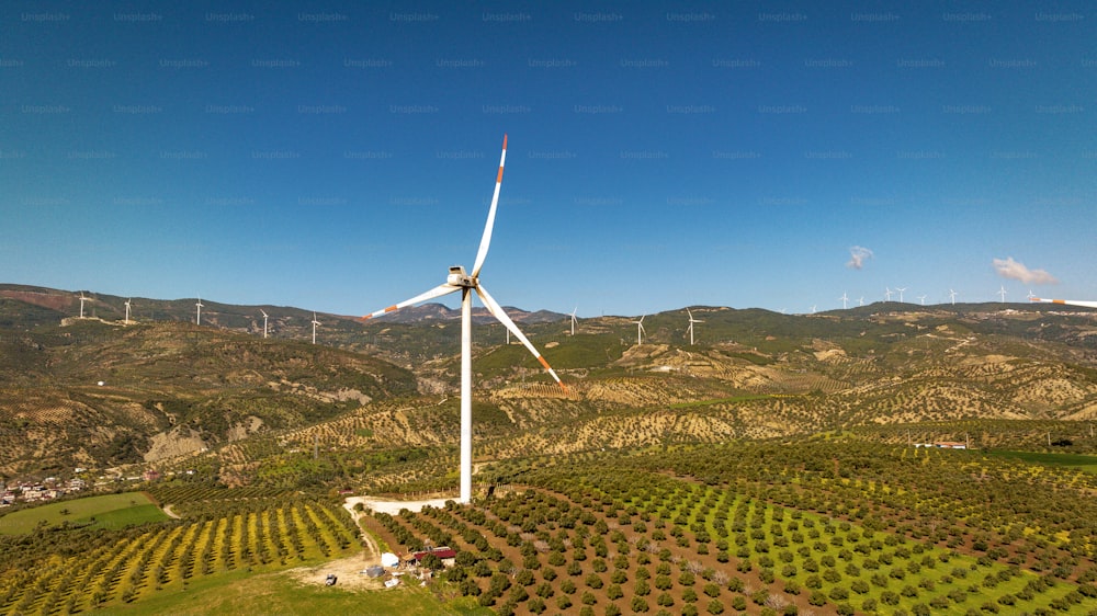an aerial view of a wind turbine in a field
