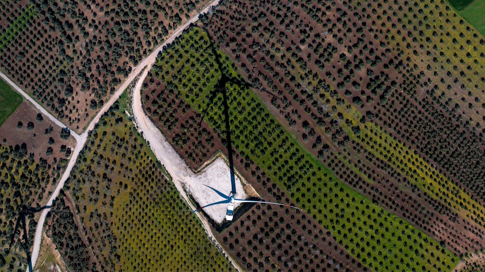 an aerial view of a wind farm with a wind turbine
