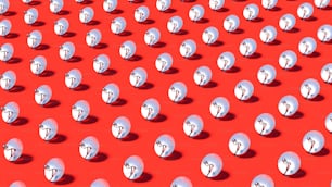a large group of small white objects on a red surface