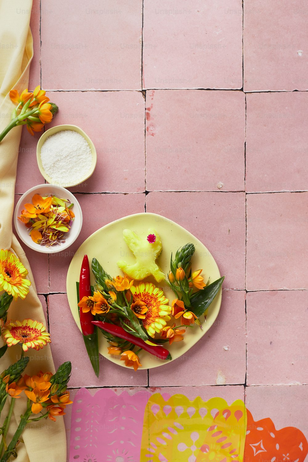 a plate of food on a pink tile floor