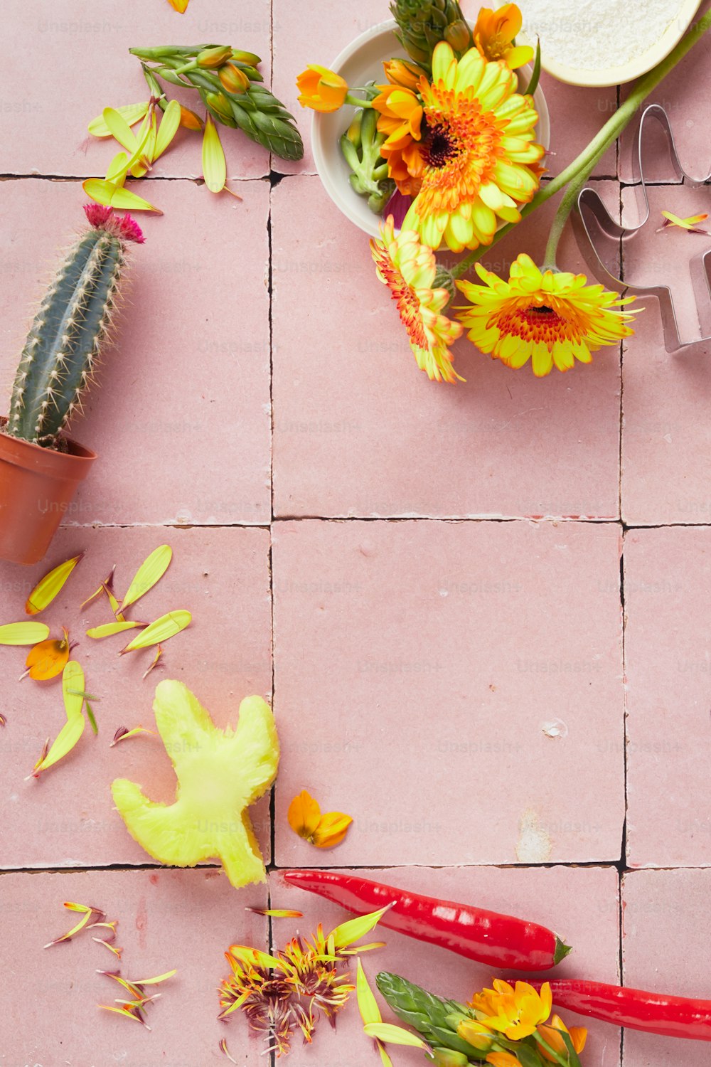 um piso de azulejos rosa com flores e tesouras sobre ele