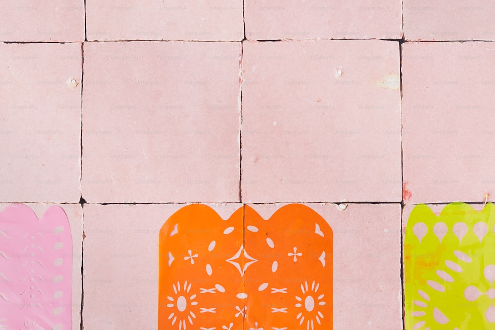 a couple of pieces of paper sitting on top of a tiled floor