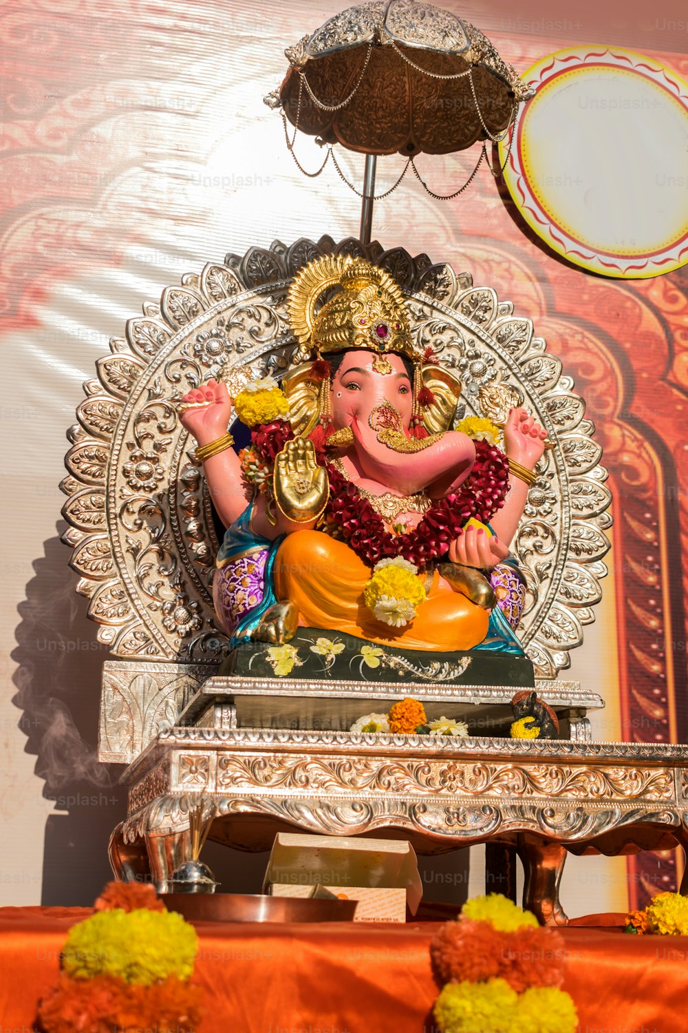 a statue of an elephant sitting on top of a table