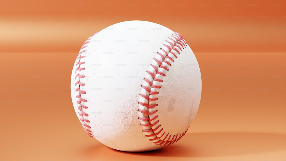 Una pelota de béisbol blanca con puntadas rojas sobre un fondo naranja